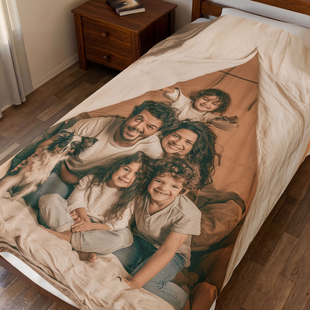 Personalized family photo blanket folded on a bed